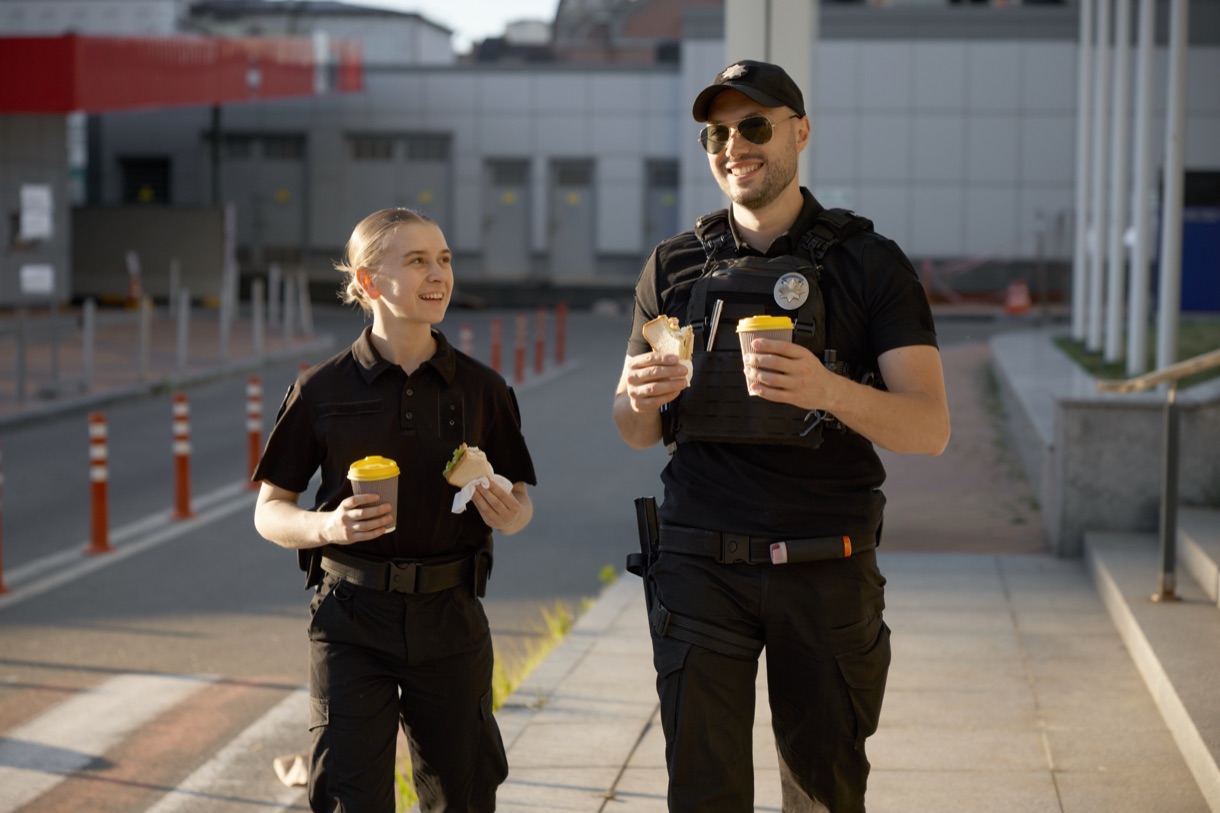 Officers and residents talking over coffee at a downtown community event