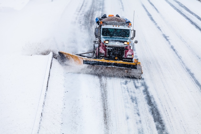 A snow plough clearing a city street
